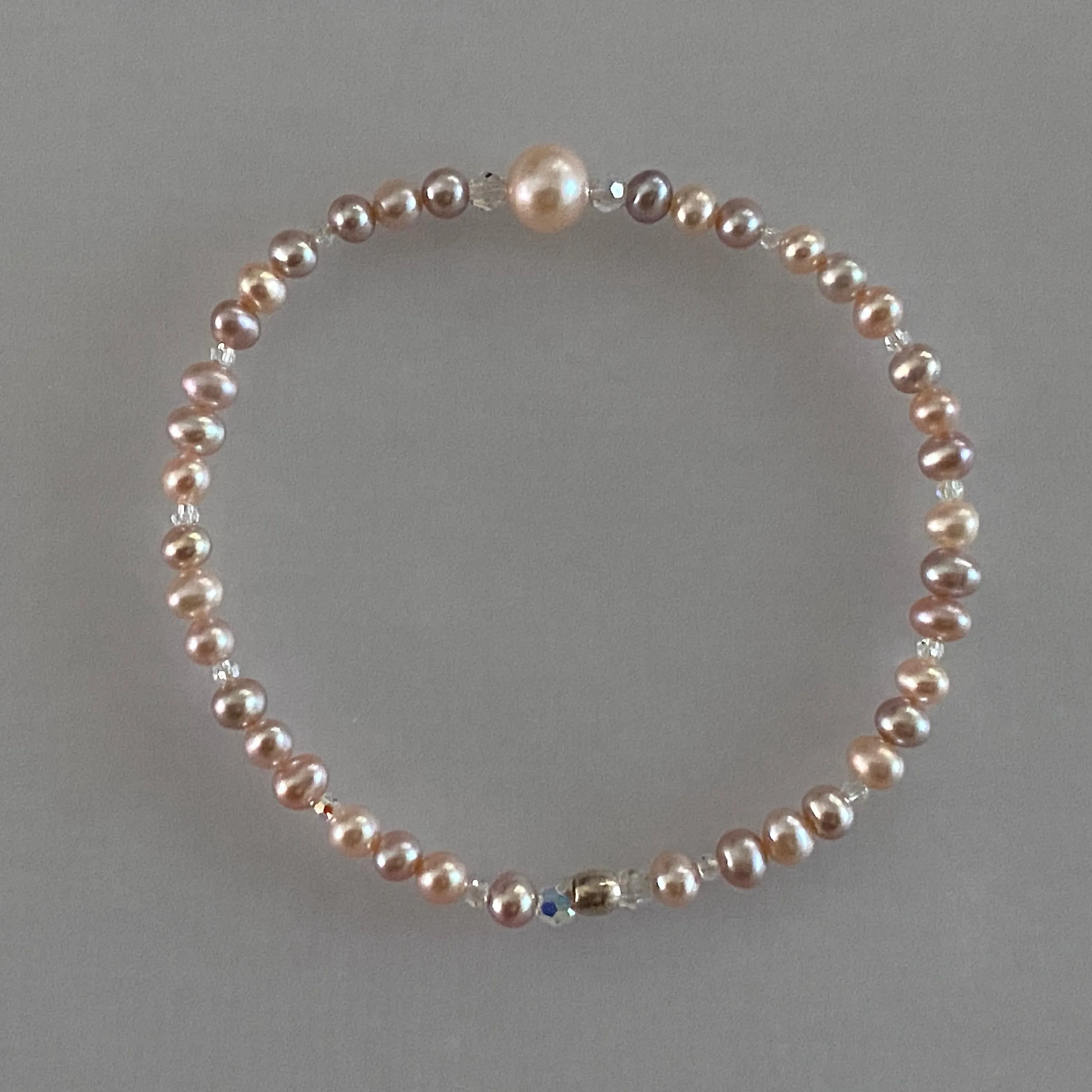 Arpaia 7" stretch bracelet with natural pastel color freshwater cultured pearls and Swarovski crystal beads